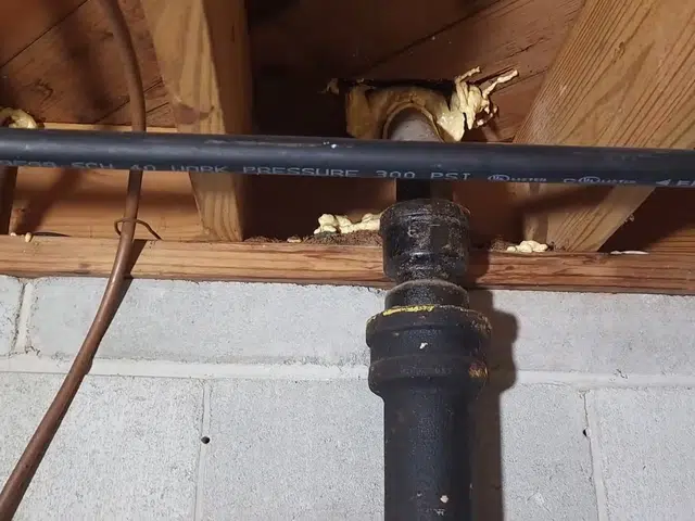 Corroded cast iron pipe section with visible rust and buildup related to Cast iron drain buildup in a heritage Monrovia home