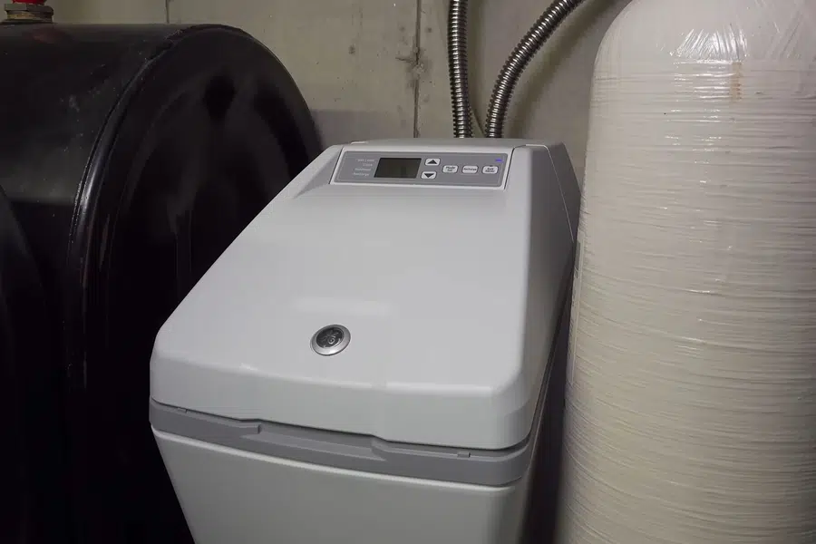 Open water softener brine tank with salt and service parts visible related to Scale-free fixtures with softened water in Monrovia