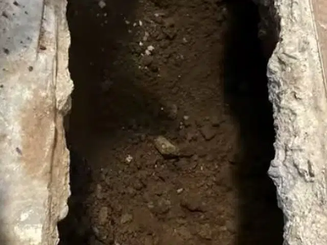 Excavated pipe repair area with exposed underground plumbing related to Sewer cleanout access in a Monrovia yard