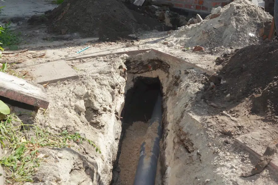 Excavated pipe repair area with exposed underground plumbing related to Soil-stressed sewer line in the Monrovia foothills