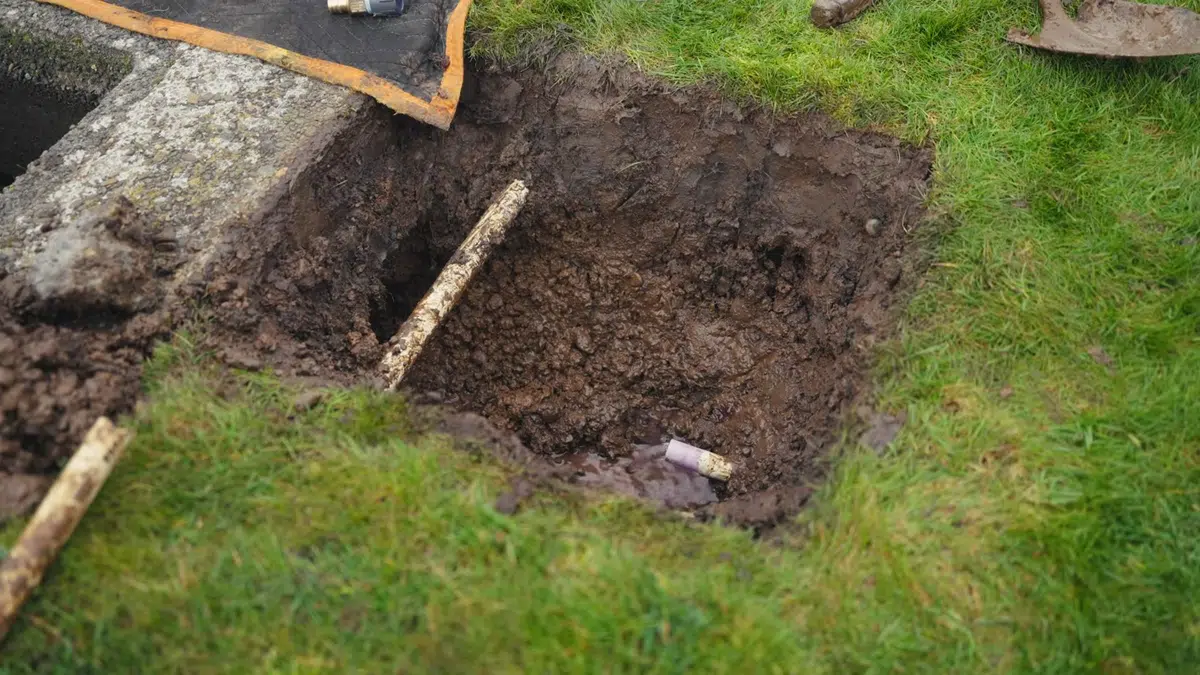 Excavated pipe repair area with exposed underground plumbing related to Sewer line replacement in Monrovia
