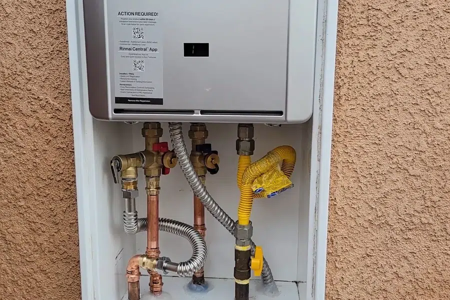 Wall-mounted tankless water heater with gas and water connections related to Descaling a tankless water heater in Monrovia