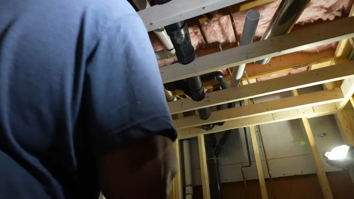 Crawlspace plumbing with drain and supply lines below the floor related to Plumber serving a South Pasadena home