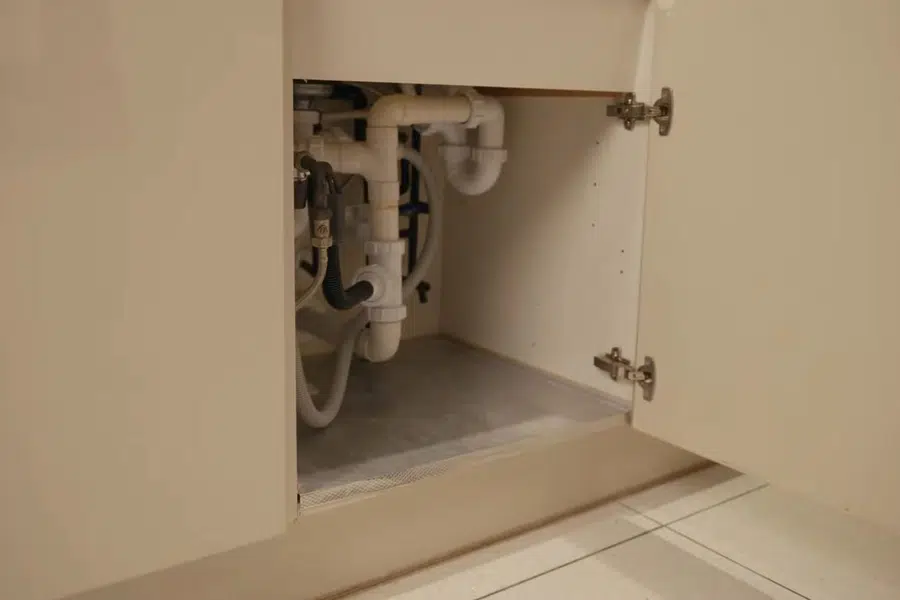 Under-sink reverse osmosis filter system connected below a cabinet related to Faucet cartridge repair in Monrovia