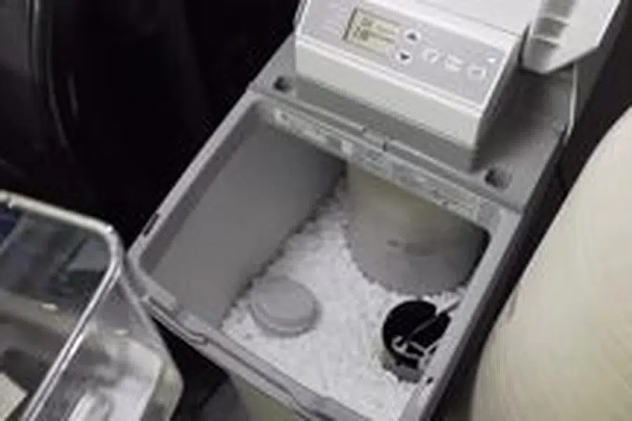 Open water softener brine tank with salt and service parts visible related to Repiping a Pasadena home
