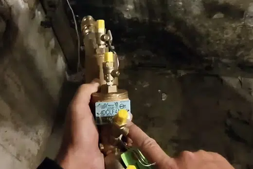 Gas line valve and water heater piping connection being checked related to Gas Line Installation and Repair in Monrovia