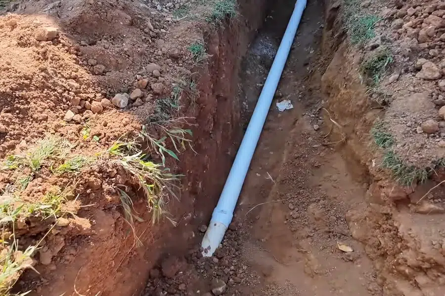 Corroded cast iron pipe section with visible rust and buildup related to Plumbing service documentation