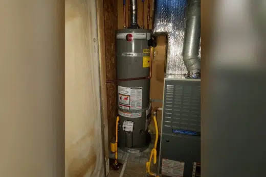 Tank water heater with nearby valves, venting, and supply connections related to Monrovia Hills neighborhood