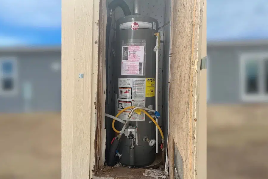 Tank water heater with nearby valves, venting, and supply connections related to Downtown Sierra Madre at the San Gabriel foothills