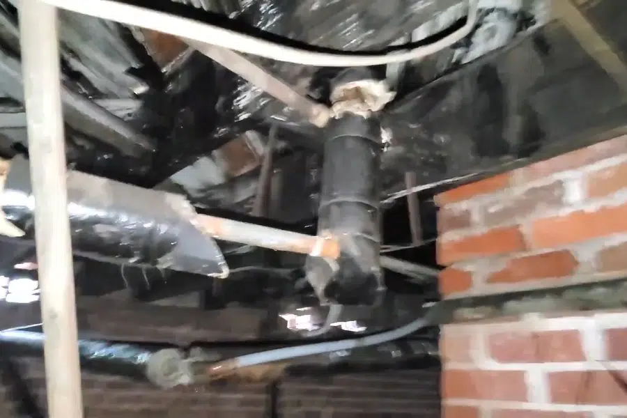 Crawlspace plumbing with drain and supply lines below the floor related to Checking the water meter for a leak in Monrovia