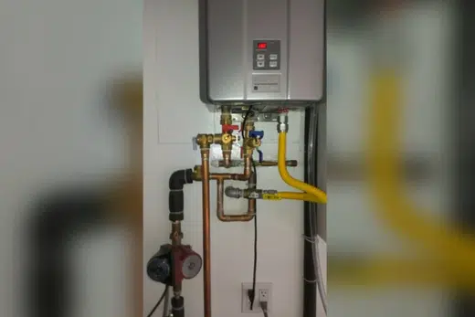 Tank water heater with nearby valves, venting, and supply connections related to Myrtle Avenue Corridor neighborhood