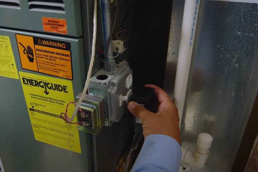 Gas line valve and water heater piping connection being checked related to New gas line for a range in Monrovia