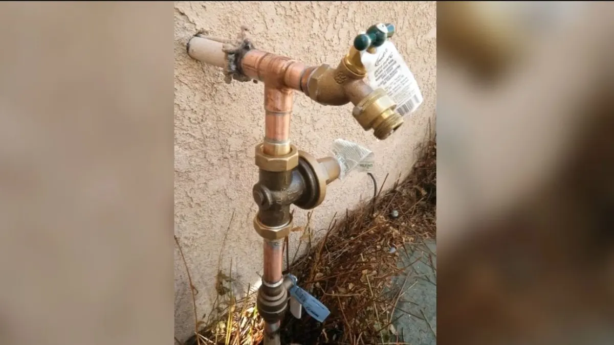 Outdoor hose bib and wall faucet connection being checked during repair in Monrovia