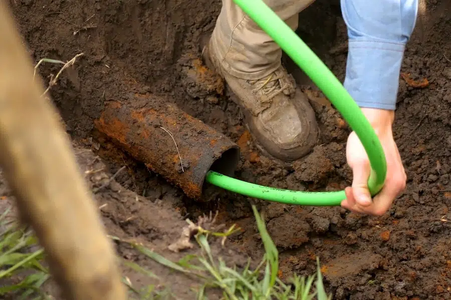 Corroded cast iron pipe section with visible rust and buildup related to Trenchless pipe bursting in Monrovia