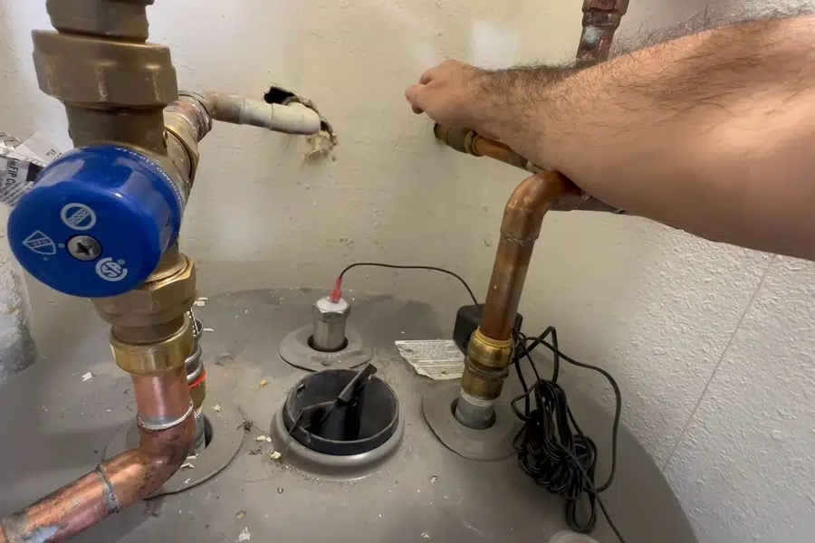 Water heater anode rod being removed for inspection related to Code-compliant water heater venting in Monrovia