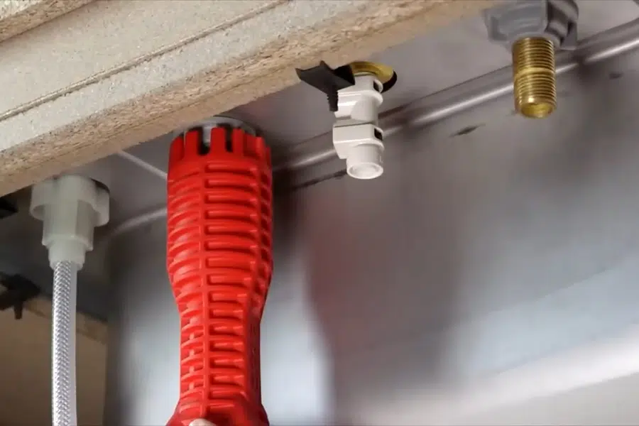 Close-up plumbing repair detail with pipes, fittings, and hand tools related to Burst pipe repair in Monrovia