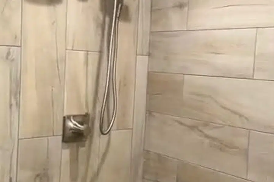 Finished bathroom shower and bathtub fixtures with clean tile surfaces related to Repiping a Glendora home