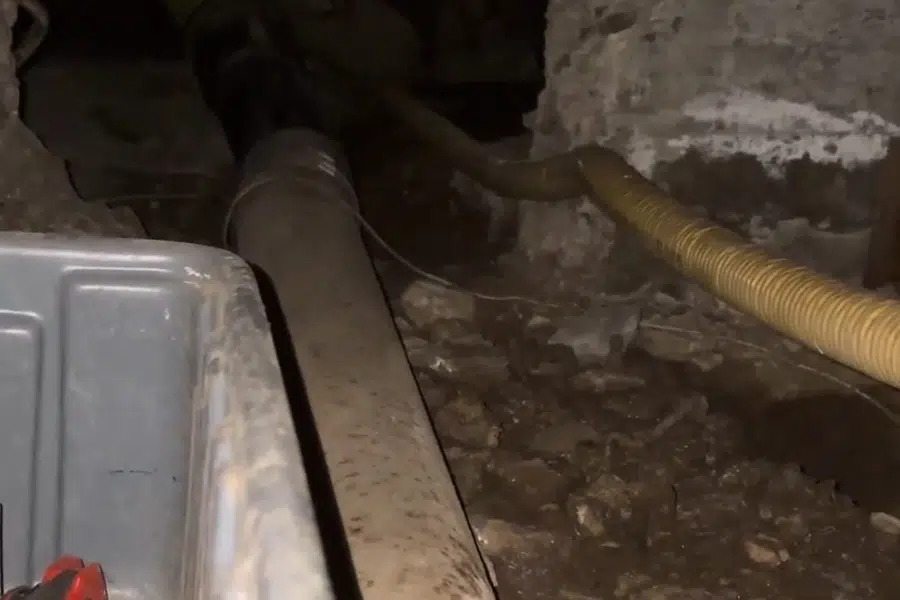 Crawlspace plumbing with drain and supply lines below the floor related to Plumber repiping or running a sewer camera in a Monrovia home