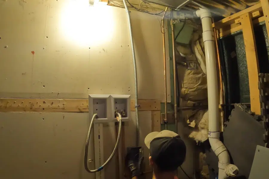 Crawlspace plumbing with drain and supply lines below the floor related to Arcadia below the San Gabriel Mountains