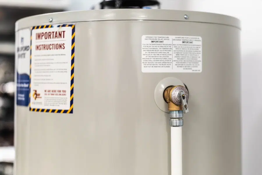 Tank water heater with nearby valves, venting, and supply connections related to Scale inside a Monrovia water heater