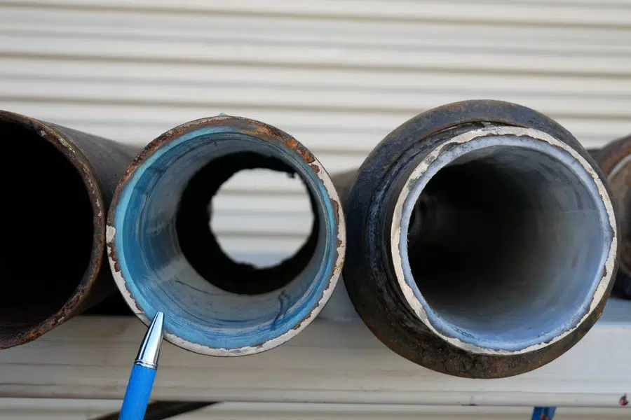 Close-up plumbing repair detail with pipes, fittings, and hand tools related to Monrovia and the surrounding west San Gabriel Valley foothills