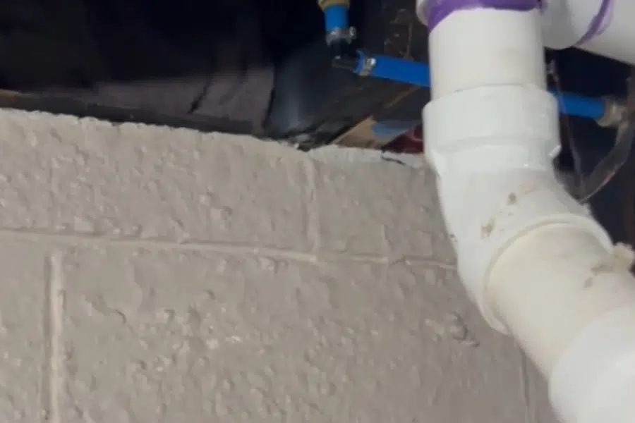 Close-up plumbing repair detail with pipes, fittings, and hand tools related to Shutting off water for a burst pipe in Monrovia