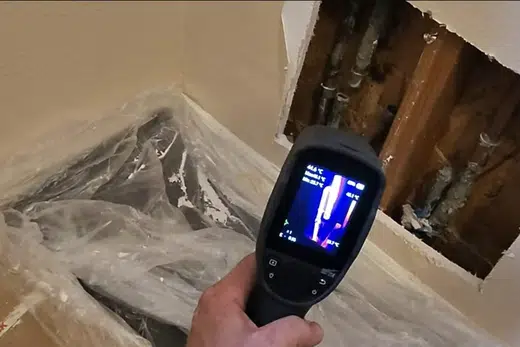 Technician using leak detection equipment around hidden plumbing related to 6 Signs of a Hidden Water Leak, Monrovia plumbing guide