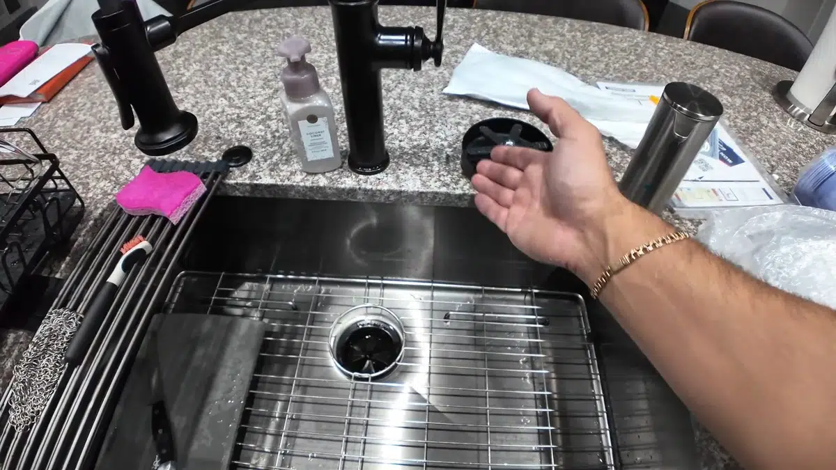 Kitchen sink faucet and drain parts being checked during faucet repair in Monrovia