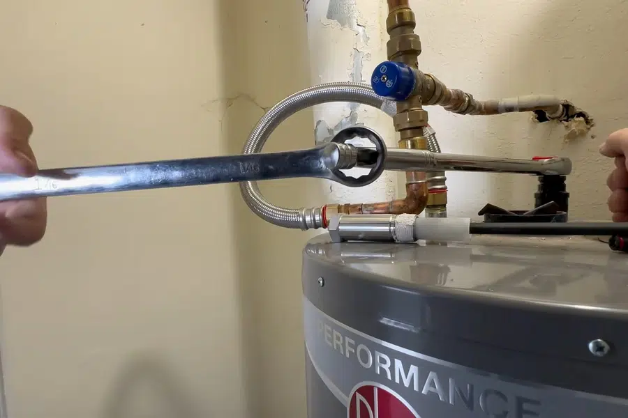 Water heater anode rod being removed for inspection related to Seismic strapping a new water heater in Monrovia