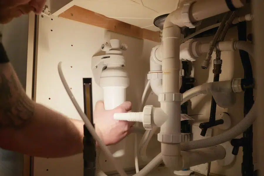 Under-sink reverse osmosis filter system connected below a cabinet related to Under-sink leak repair in Monrovia