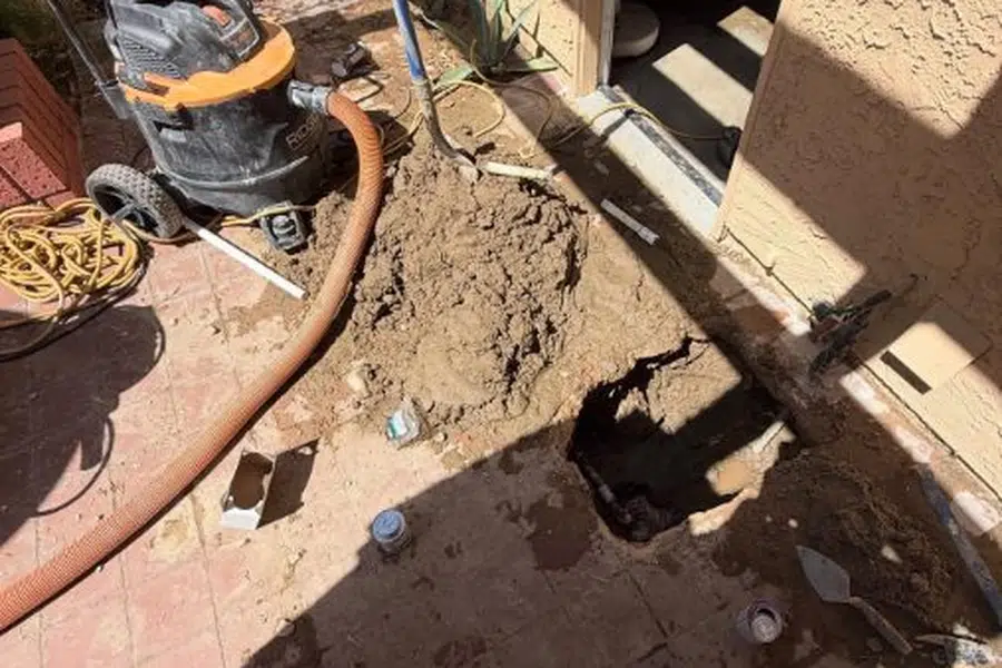 Concrete floor or slab opened to expose leaking plumbing below related to Signs of a slab leak in a Monrovia home