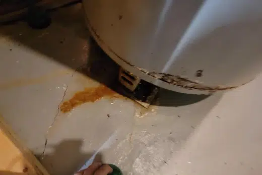 Plumber working on gas water heater piping and controls related to Water Heater Lifespan Guide, Monrovia plumbing guide