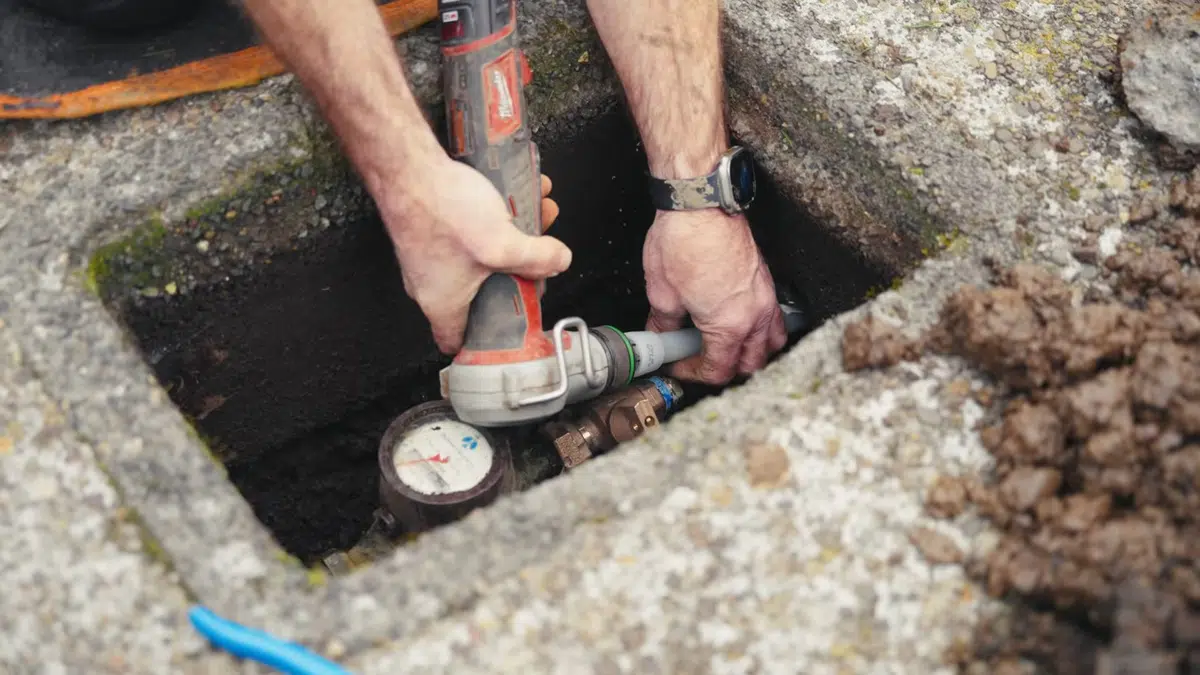 Excavated pipe repair area with exposed underground plumbing related to Water line replacement in Monrovia